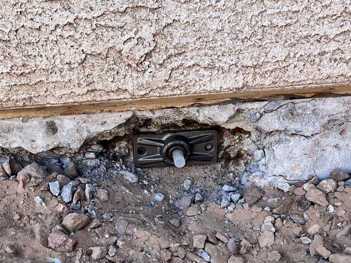 New cast-iron post-tension anchor installed in a repaired slab edge